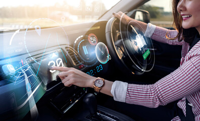 Auto pilot self driving car businesswoman using interactive dashboard, HUD Head Up Display and digital instruments panel autonomous user interface navigation utility screen smart technology hologram