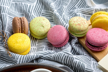 Multicolored macarons on a printed linen napkin