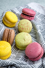 Multicolored macarons on a printed linen napkin