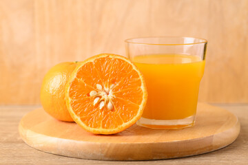 Fresh Honey Murcott orange fruit and juice on wooden background, Healthy drink