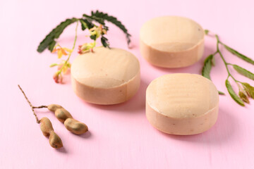 Tamarind soap on pink background, organic natural product for skin care