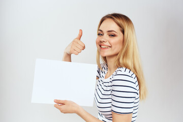 Naklejka premium woman holding a sheet of paper in her hands lifestyle striped t-shirt cropped view Copy Space