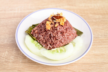 Northern Thai food (Khao Kan Chin or Khao Ngiao), Steamed rice mixed with pork blood eating with fried chopped garlic, fried chili and fresh cucumber