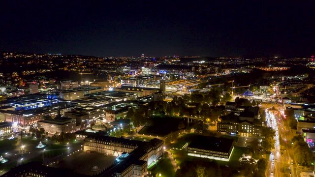 Aerial night time lapse in 4k of downtown skyline in the city of Stuttgart, Germany  from left to right.