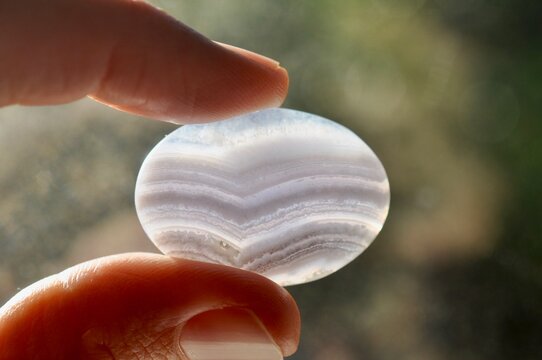 Hand holding pretty agate stone