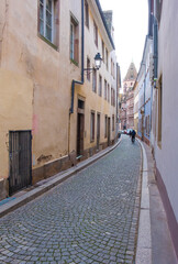 Fototapeta na wymiar an old narrow street in strasbourg, alley by cobblestoned,