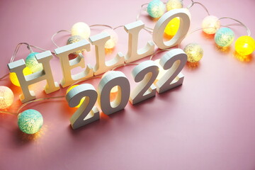 Hello 2022 alphabet letter with cotton ball LED decoration on pink background