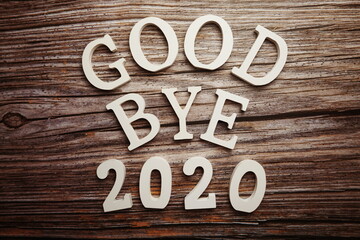 Goodbye 2020 alphabet letter on wooden background