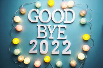 Goodbye 2022 alphabet letter with cotton ball LED decoration on blue background