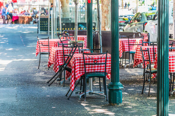 Chairs and tables at a outdoor cafe on Lygon Street, Carlton, Melbourne, Australia