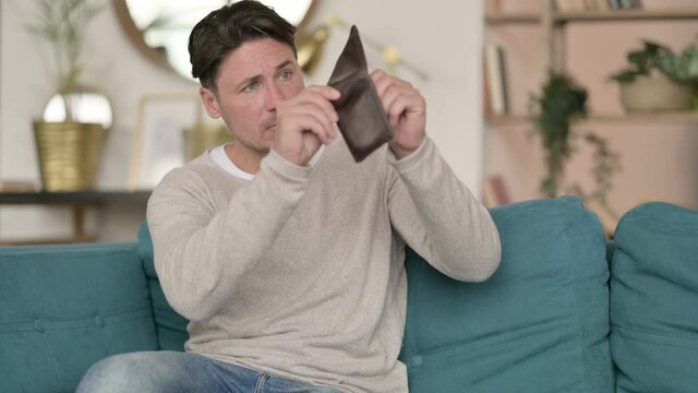 Broke Middle Aged Man Check Empty Wallet, at Home