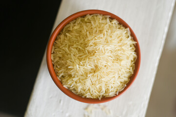 Traditional Indian raw basmati Rice used to make biryani or pulao , uncooked heart healthy food with Indian spices Kerala India. Jasmine or Jeera rice for making Biriyani or pulav 