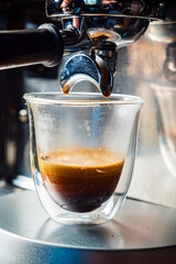  Close-up of espresso pouring from coffee machine. Professional coffee brewing