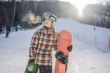 Woman snowboarder on a sunny winter day at a ski resort