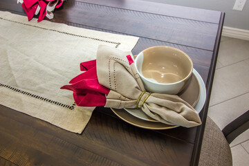 Place Setting On Wood Dining Area Table With Cloth Runner