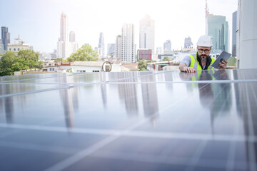 Rooftop solar power plant engineers sitting and examining photovoltaic panels. Concept of alternative energy and its service. Electrical and instrument technician use laptop to maintenance electric sy
