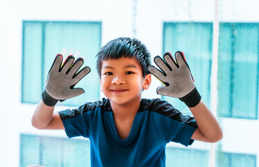 Happy soccer boy goalkeeper showing his football keeper gloves
