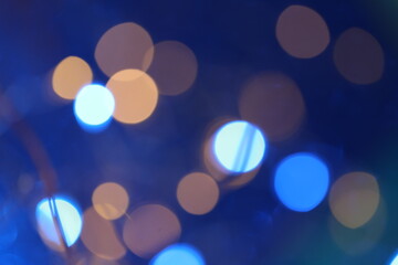 Bokeh background blue colors.Wallpaper phone shining blue bokeh.Winter beautiful shining abstract background in cold colors. Festive shiny bokeh  texture.Cyan and dark blue bokeh background