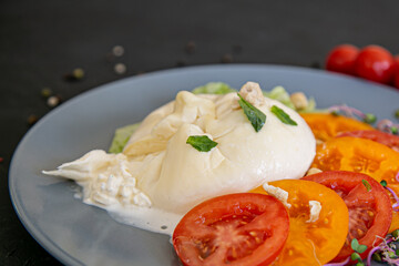 Burrata cheese with tomatoes and herbs 