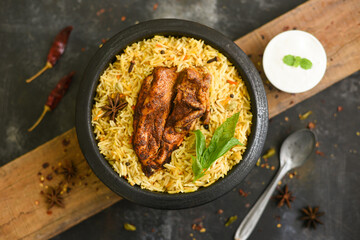 Arabic chicken Manthi or mandi cooked meat, Basmati rice with Masala, spice. Kuzhimanthi or hot and spicy Manthi on black background in Malabar Kerala, South India. Top view of Indian non veg food.