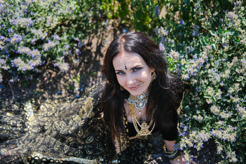 Woman in ethnic indian costume with gold jewellery and traditional makeup.