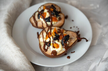 Sweet baked pears with cottage cheese and dried fruits, decorated with chocolate