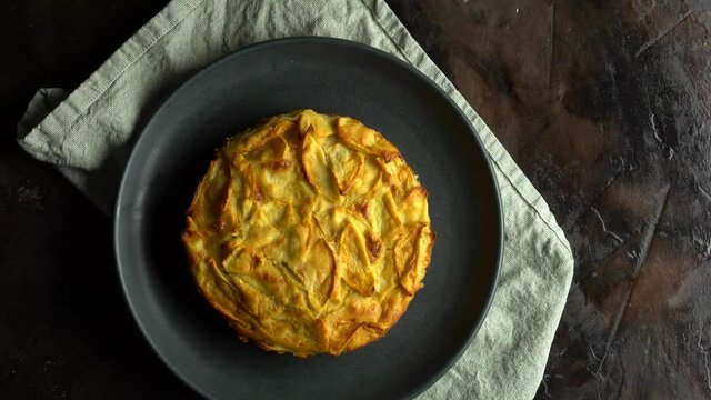 Homemade cakes Apple pie with baked goods on the dark rusty wooden kitchen table red and green apples with cinnamon. Traditional American dessert. Flatley food background. The view from the top