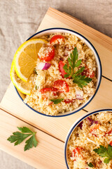 Flatlay Tabouleh is an Arabic vegetarian salad made with couscous, tomatoes, parsley. Healthy lunch