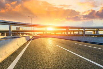 Fototapeta premium Asphalt highway and bridge construction scene at sunrise.