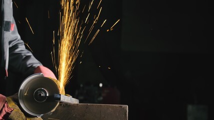 Forge workshop. Smithy manual production. Close up details of sparks, industrial worker using angle...
