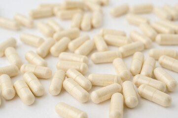 many pharmacy capsules pills drugs vitamin lying on white surface background with copy space