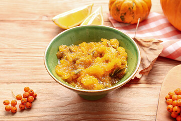 Bowl of tasty pumpkin jam on table