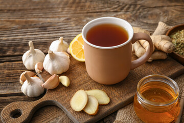 Cup of healthy garlic tea on table