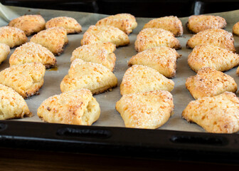 Cookies on a baking sheet. Triangular cottage cheese sugar cookies