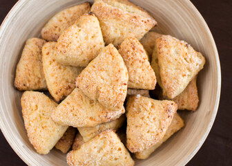 Cottage cheese ears in a plate sprinkled with sugar