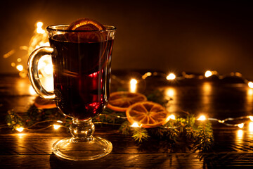 Mulled wine with cinnamon and an orange and fur-tree branches, a New Year's still-life