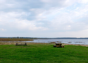 autumn landscape on the lake shore, reflections in the water, autumn colors