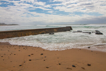 Cement Jetty Leading from Shoreline into Rough Sea