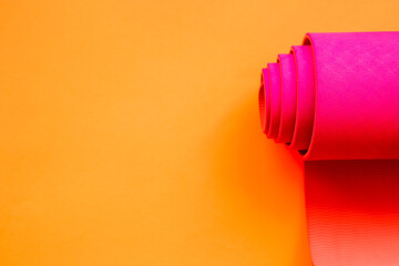 bright pink ultramarine yoga mat on orange background