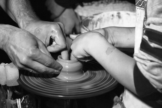 Potter teaching to make ceramic pot