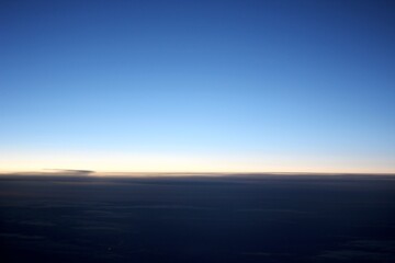 Fototapeta na wymiar blue sky above clouds from the plane window