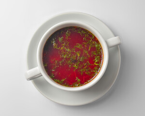 Ukrainian beetroot soup - borscht with sour cream served in a white bowl over white background.