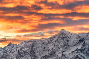 Obraz na płótnie Canvas Sunrise at mountain zugspitze in winter with snow and colorful sky. Highest german mountain. Cable car. Germany austria