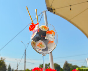 Sushi Set creative idea. Set of traditional sushi rolls served in a tall wine glass. Art interpretation.
