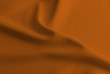 Abstract rippled orange clothes background .