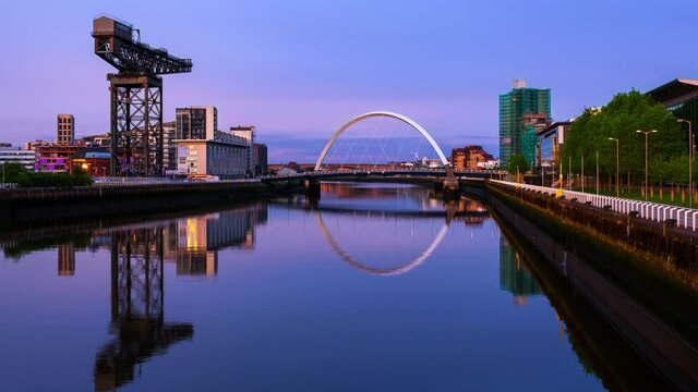 Glasgow, Scotland. View of Glasgow, UK landmarks - Finnieston Crane and Squinty bridge at sunset. Time-lapse with colorful twilight sky