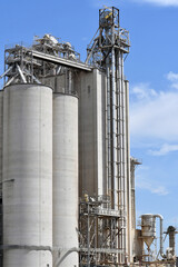 Vertical shot of a big industrial factory under a blue