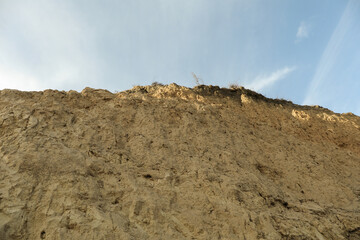 Clay slope against beautiful blue sky background