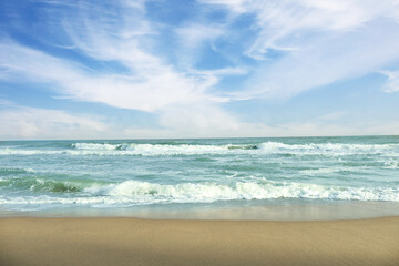 Sea with waves on beautiful sandy beach