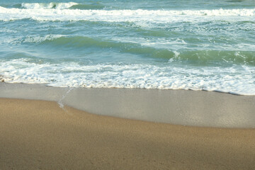 Sea with waves on beautiful sandy beach